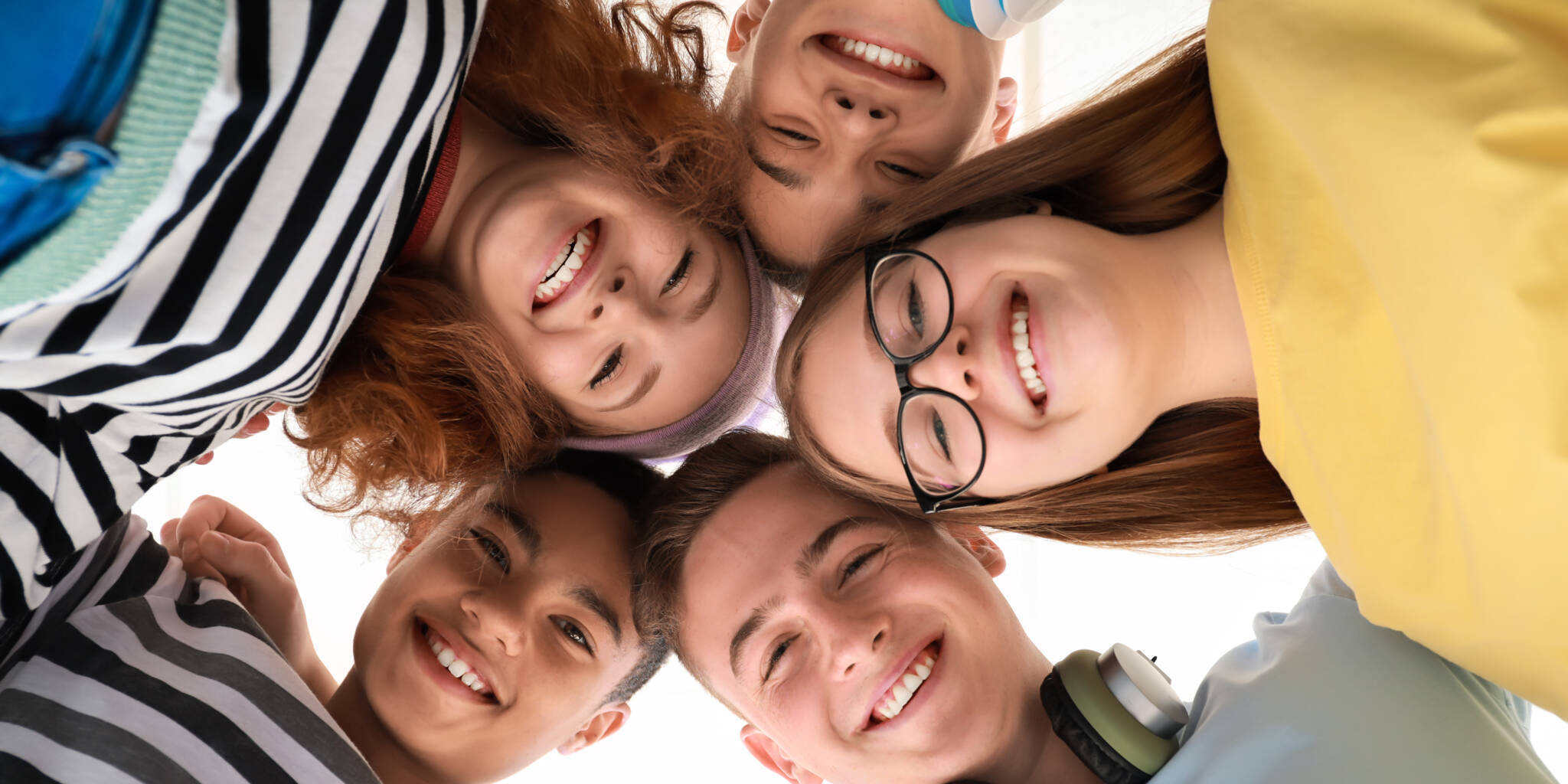 Portrait Of Teenagers On White Background, Bottom View