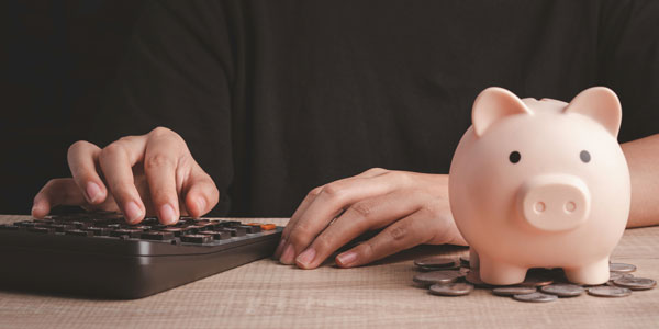 Savings Plan For The Future Concept. Hand Use A Calculator For A